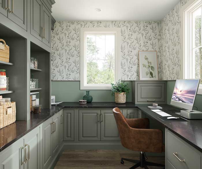 home office with floral wallpaper cool toned cabinetry and brown leather chair